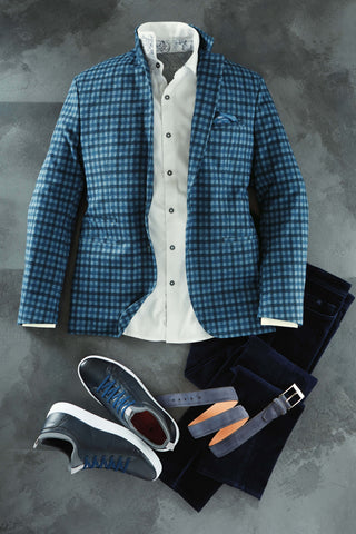 Blue checkered jacket, white shirt, black pants, and shoes on a gray background