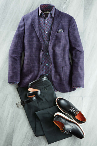 Purple checkered blazer, black dress pants, and brown shoes on a light gray background