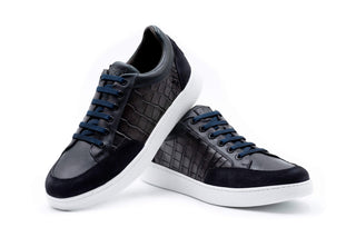 Black and gray sneakers with white soles on a white background