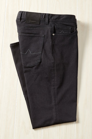 Black pants on a light wooden surface